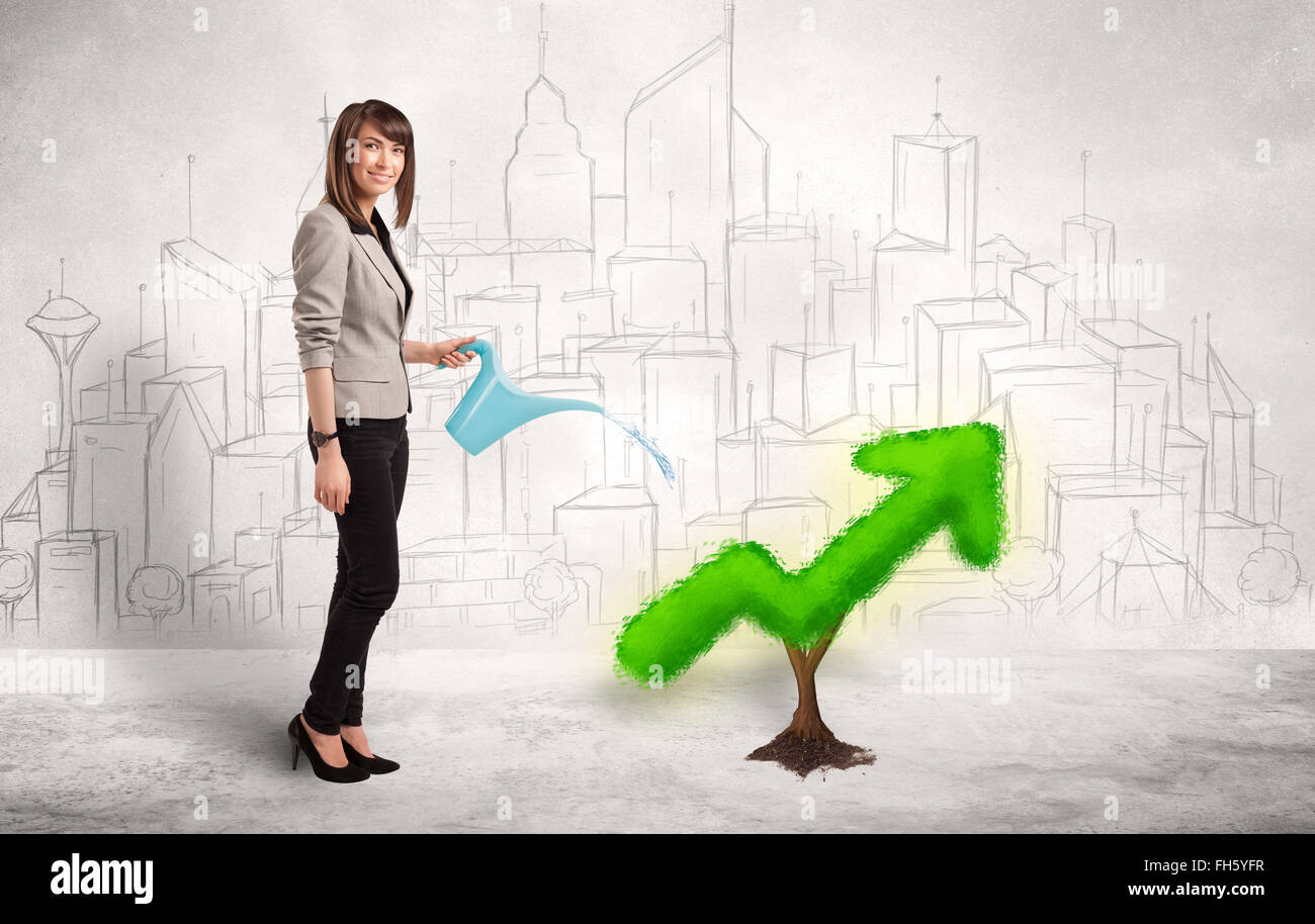 Business woman watering green plant arrow Stock Photo