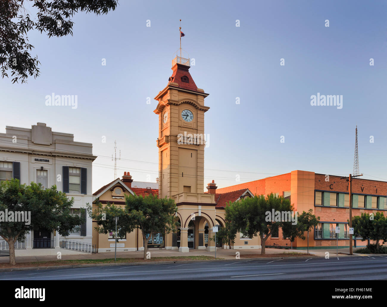 town hall facade facing street with tall clock tower at sunrise in small regional town Mildura in Victoria state of Australia Stock Photo