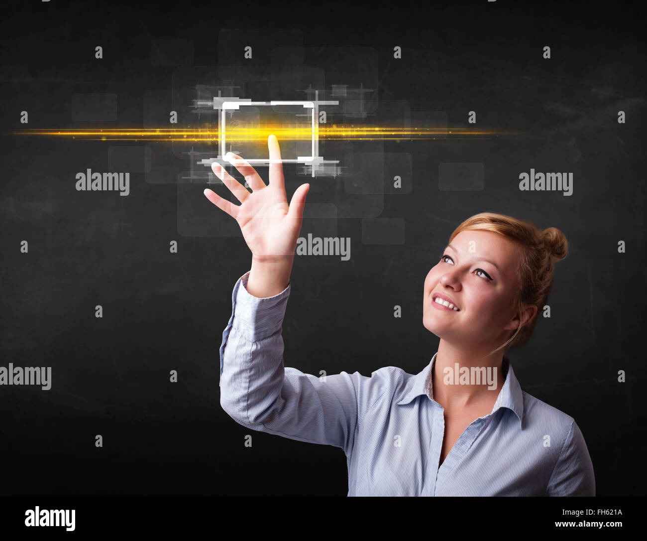 Young tech lady touching button with orange light beams concept Stock ...