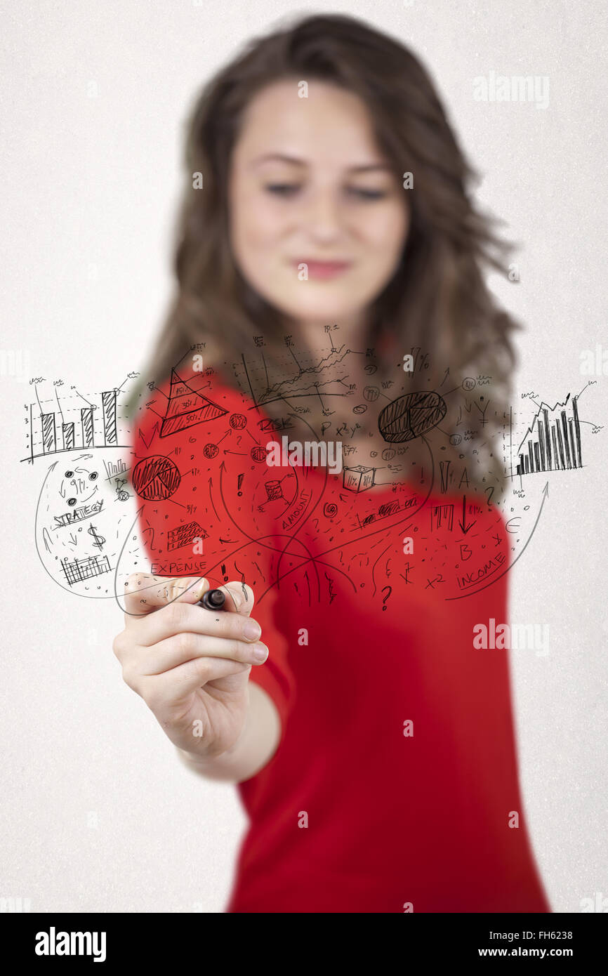 Pretty girl sketching graphs and diagrams on wall Stock Photo - Alamy