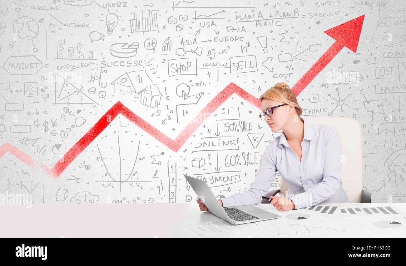 Business woman sitting at table with market diagrams Stock Photo - Alamy