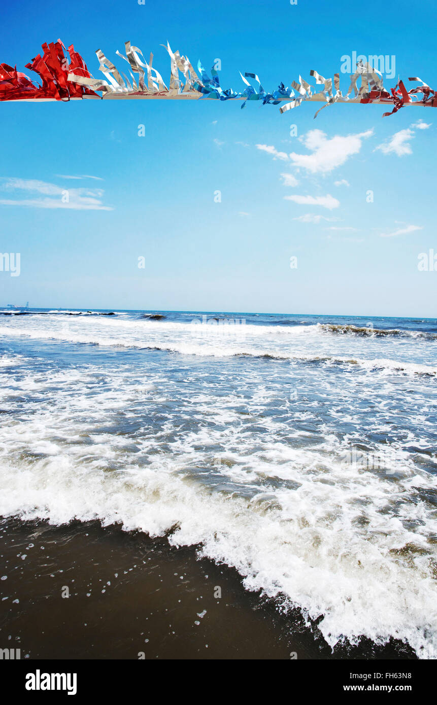 Red, White and Blue Streamers Blowing in Breeze at Beach, Atlantic