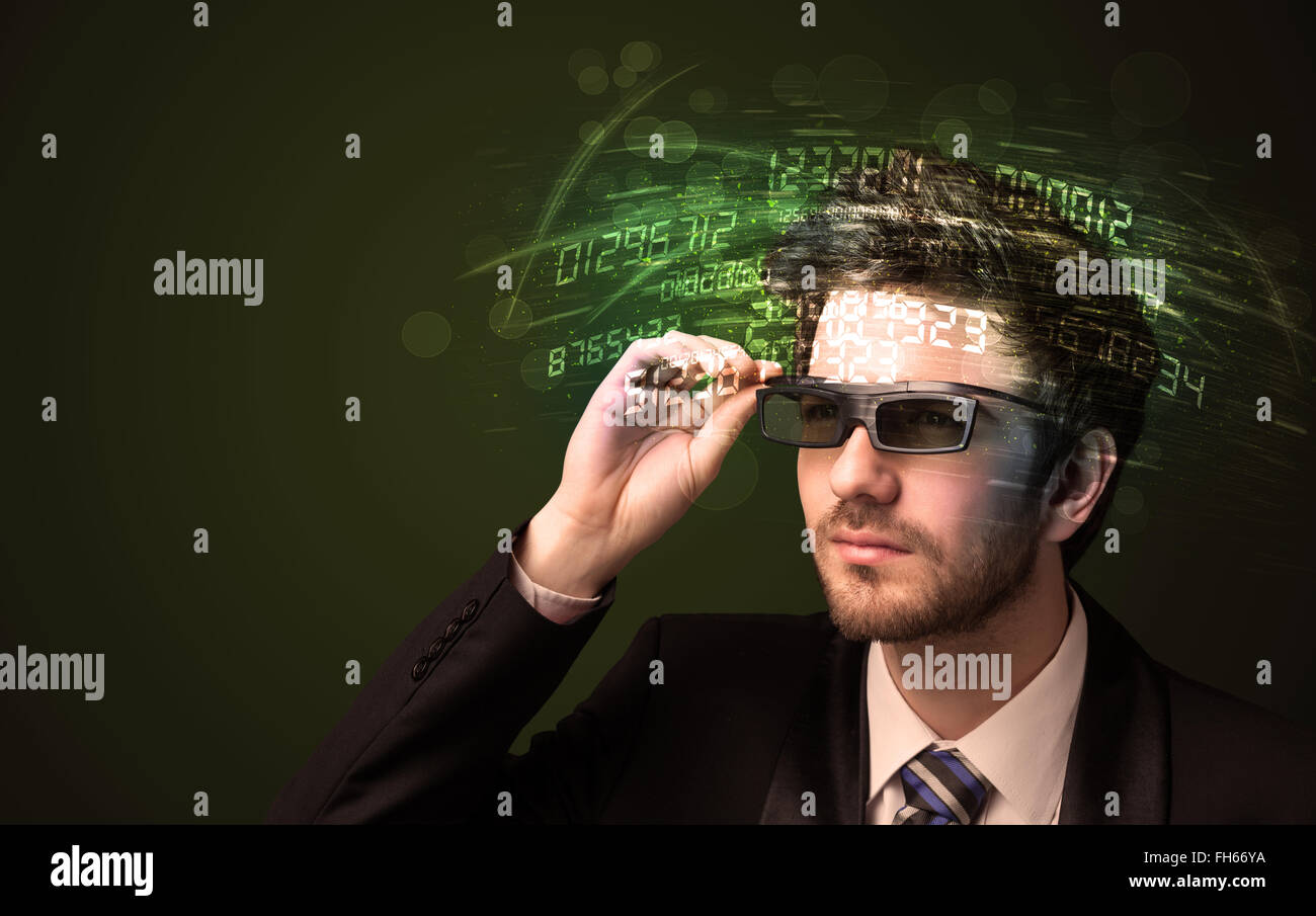 Business man looking at high tech number calculations Stock Photo
