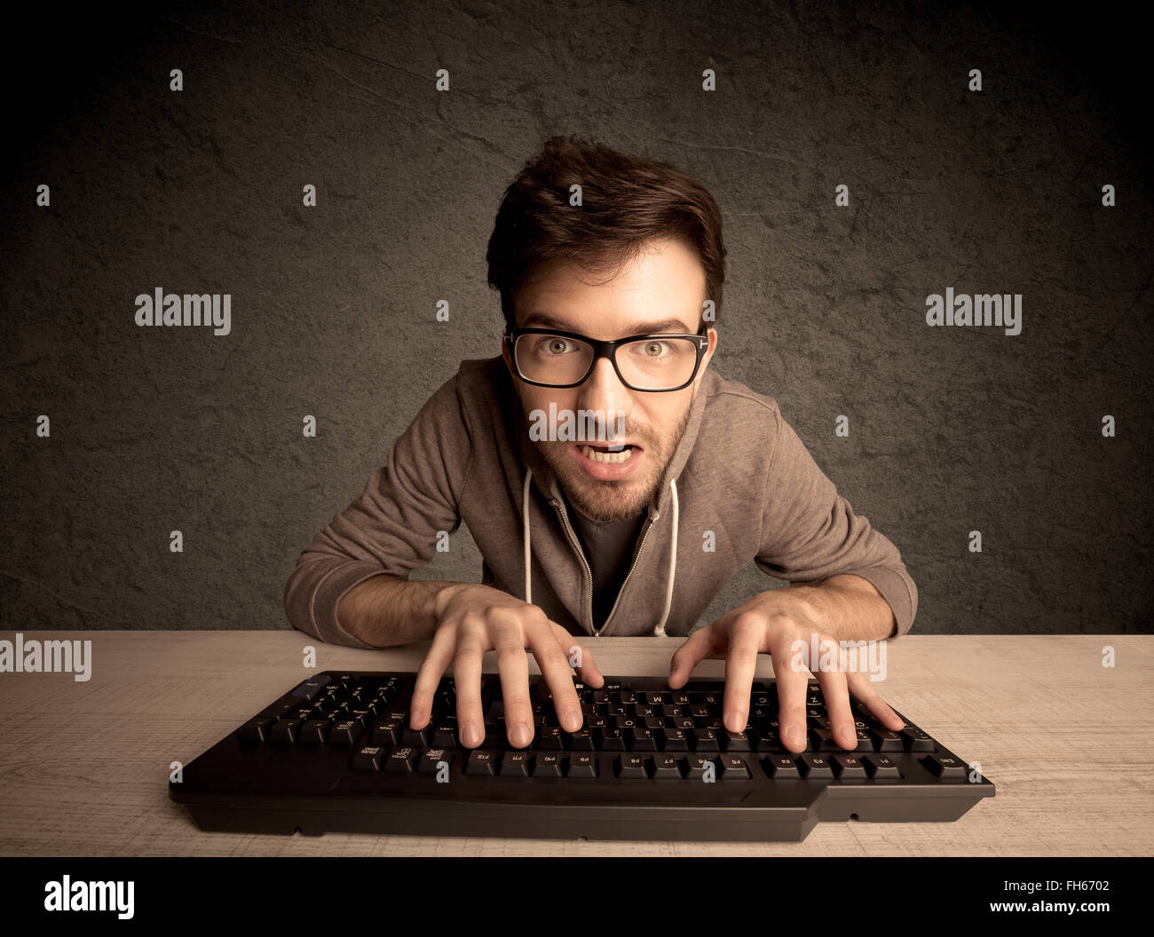 Computer geek typing on keyboard Stock Photo - Alamy