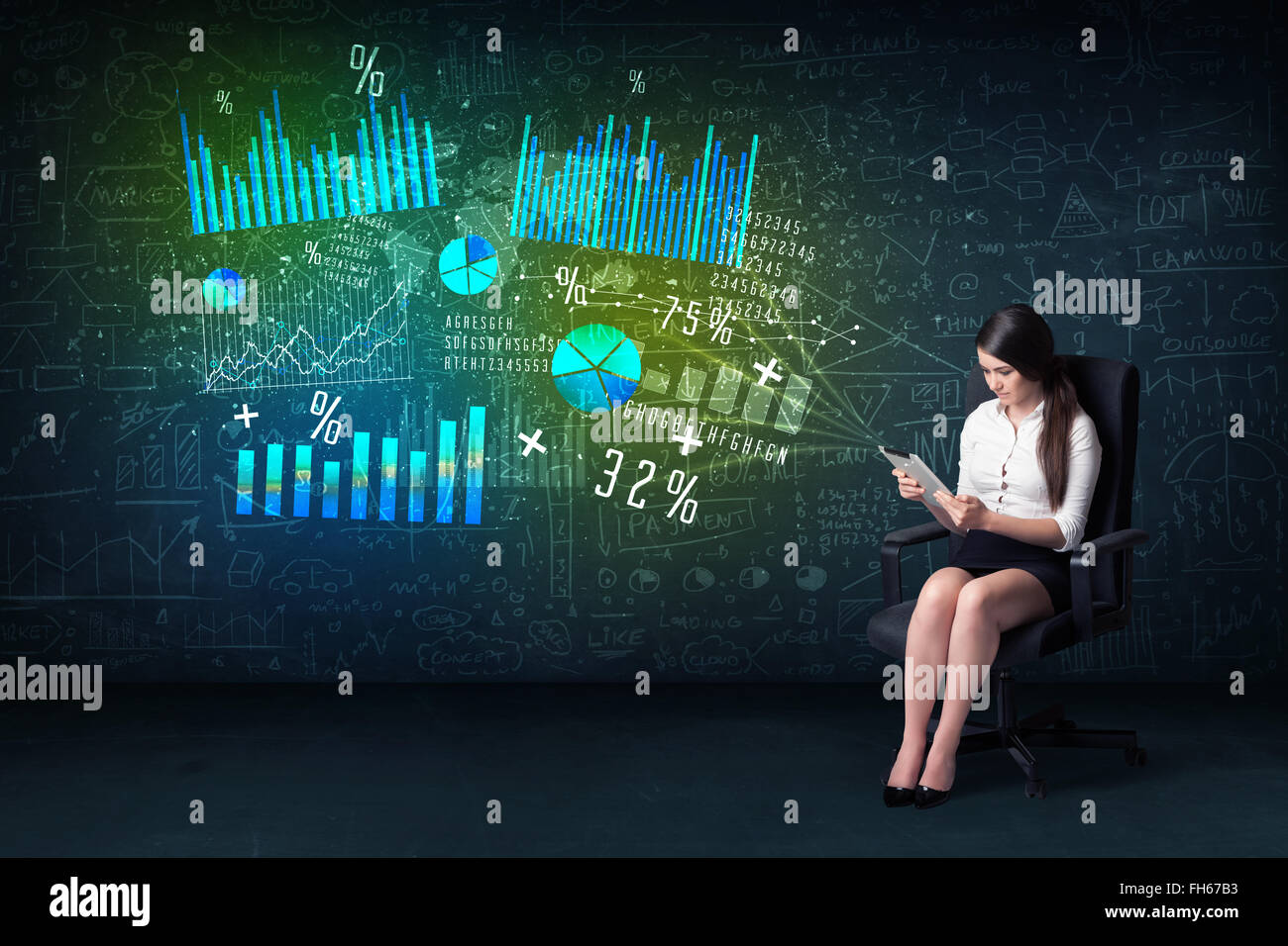 Businesswoman in office with tablet in hand and high tech graph charts Stock Photo