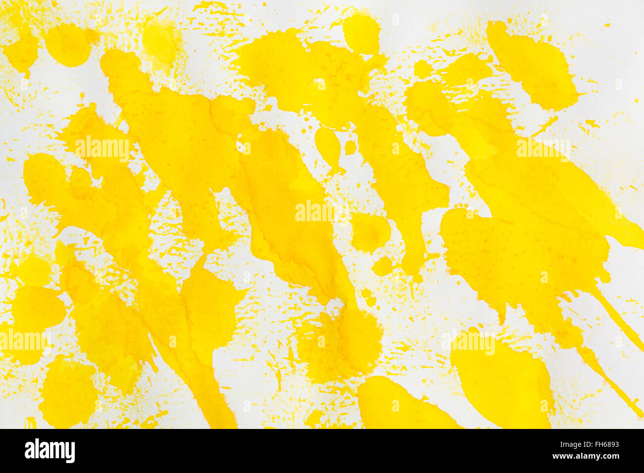 Watercolor yellow splashes abstract on white grainy paper. Design element. To use as background. Stock Photo