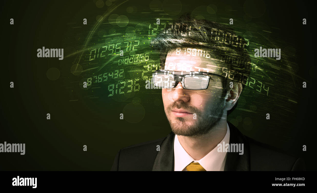 Business man looking at high tech number calculations Stock Photo - Alamy