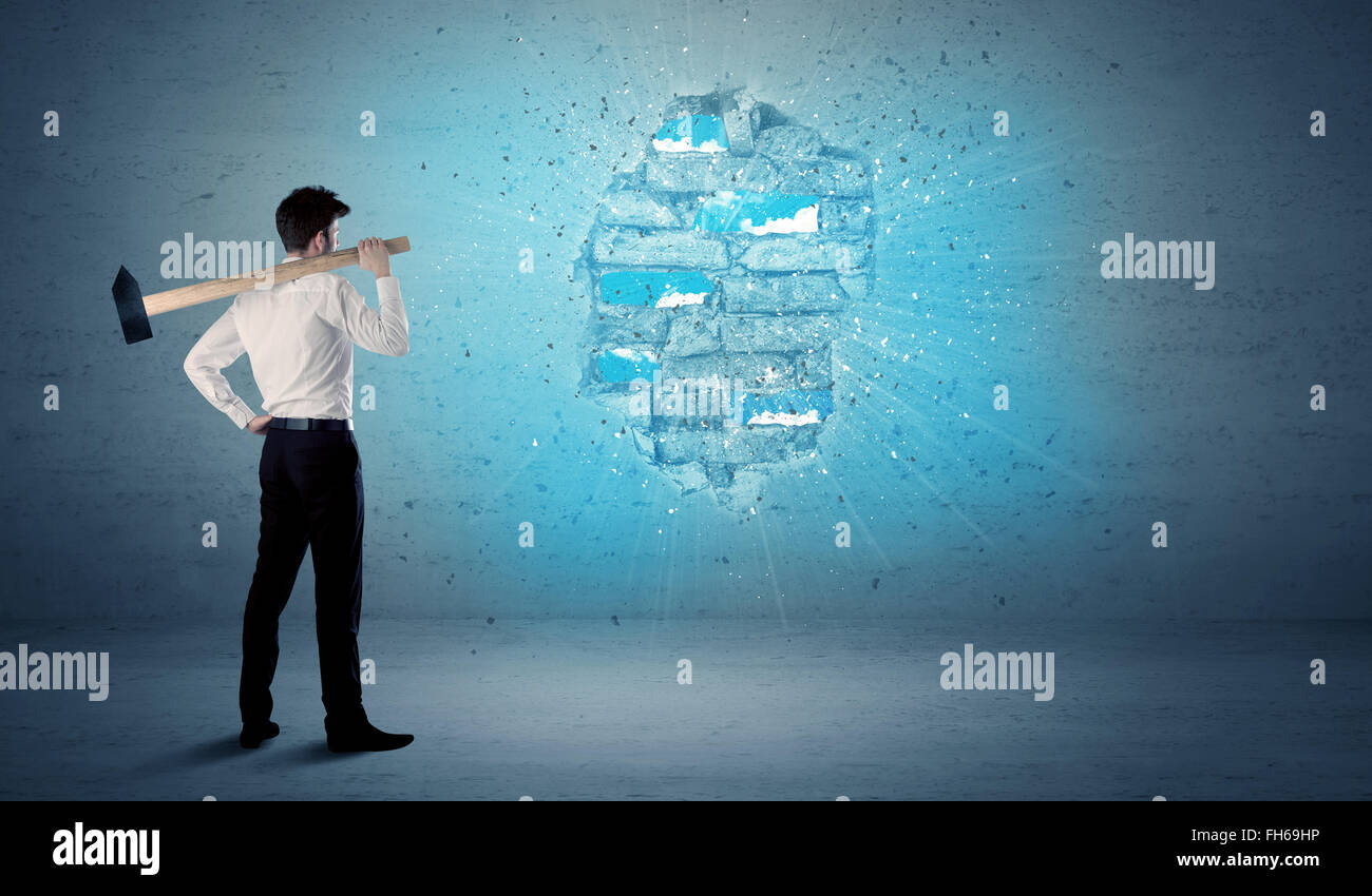 Business man hitting brick wall with huge hammer Stock Photo Alamy
