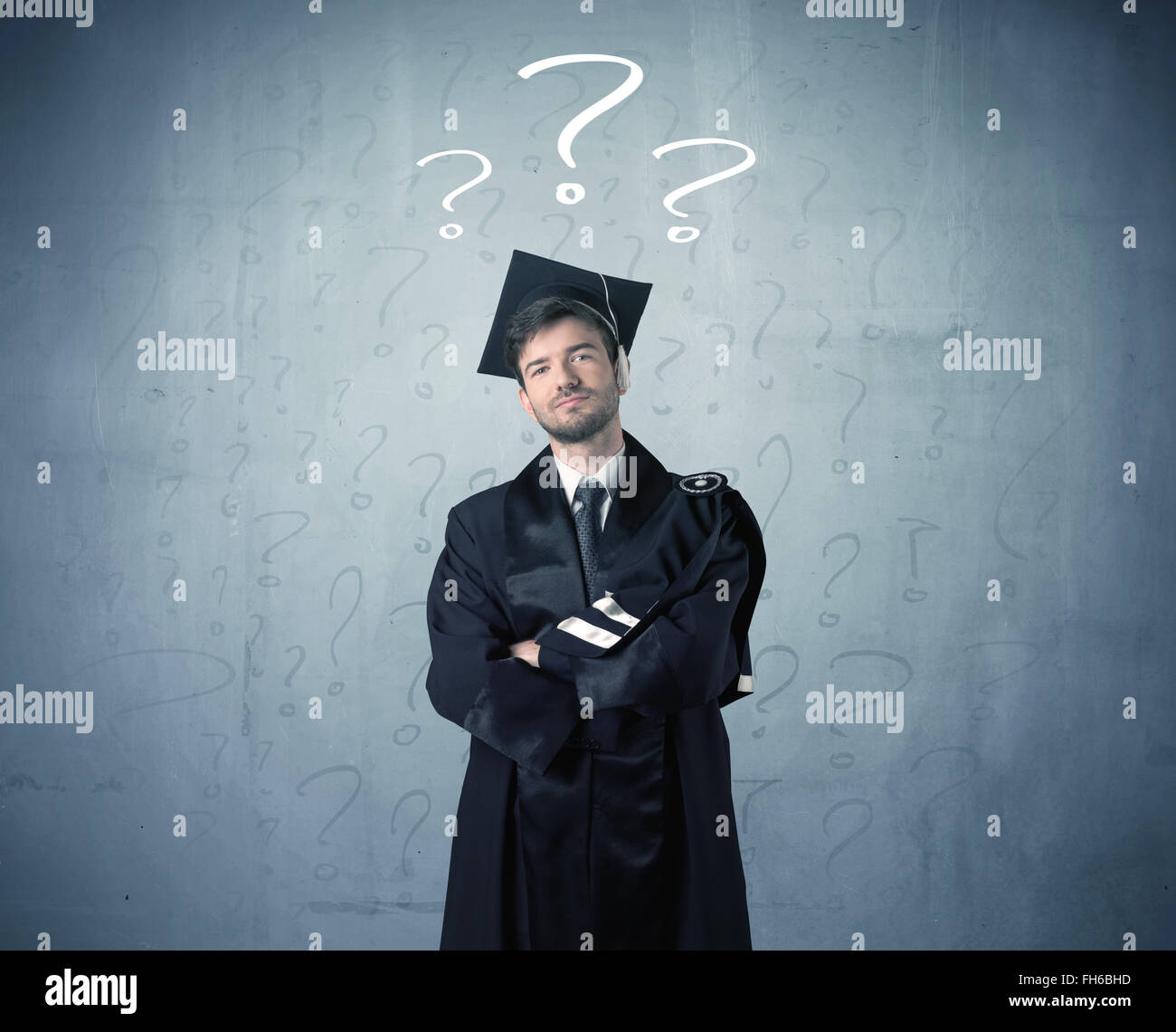 Graduate Questioning Young graduate teenager with question marks drawn Stock Photo - Alamy