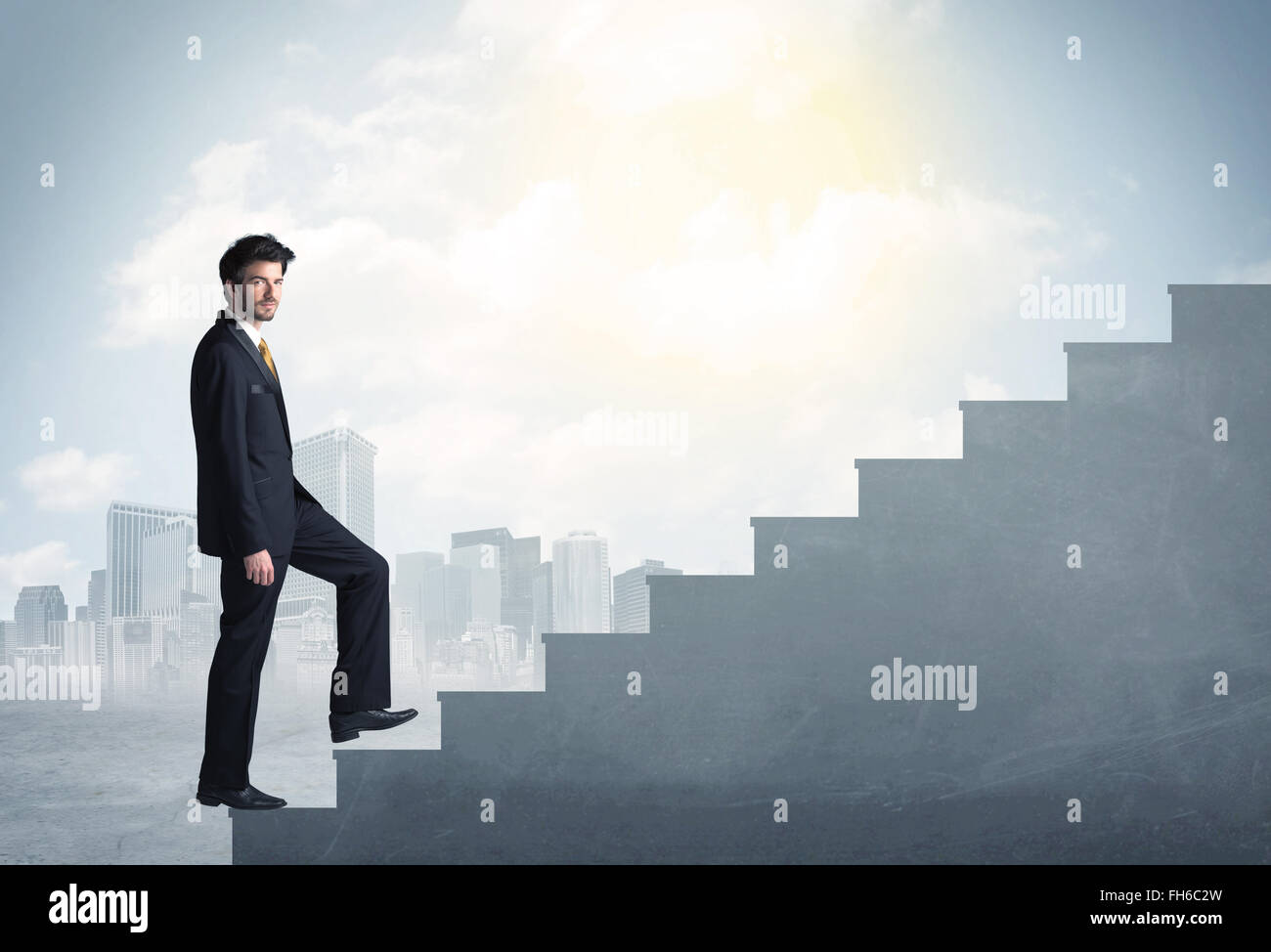 Businessman climbing up a concrete staircase concept Stock Photo