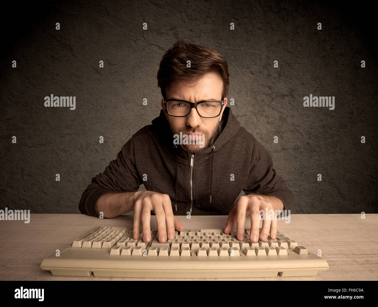 Computer geek typing on keyboard Stock Photo - Alamy