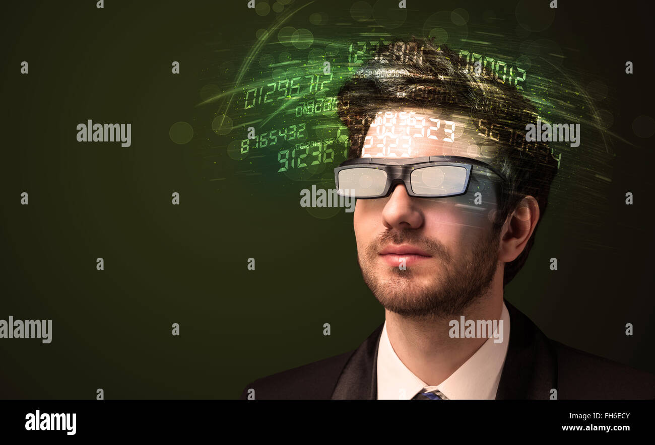 Business man looking at high tech number calculations Stock Photo - Alamy