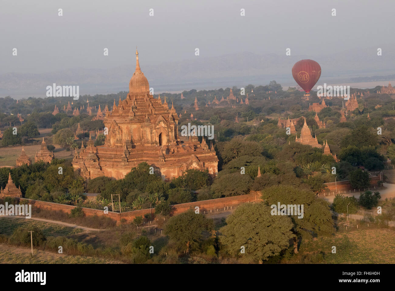 Hot air ballon floats over the archeological zone and pagodas Bagan,Myanmar Stock Photo