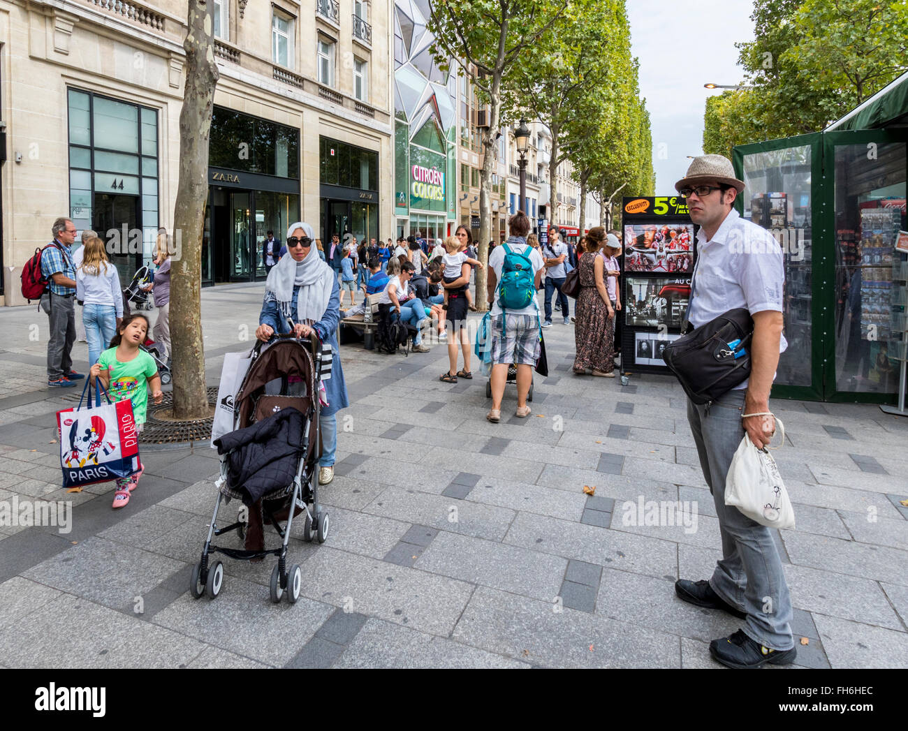 People shopping walking and resting on the famous Champ-Elysees Paris ...