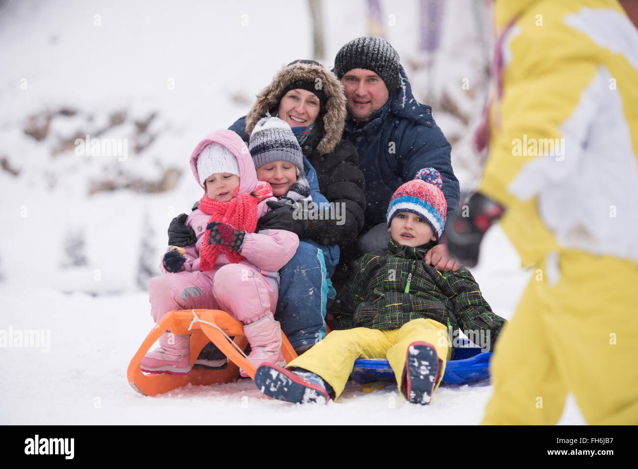 group of children having fun and play together in fresh snow on winter ...