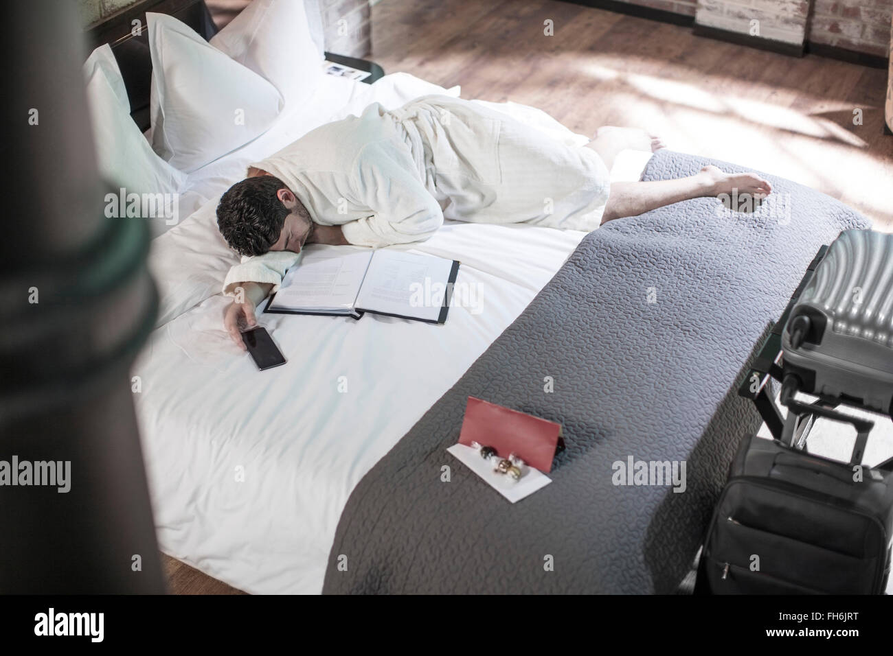 Man on hotel bed sleeping Stock Photo Alamy