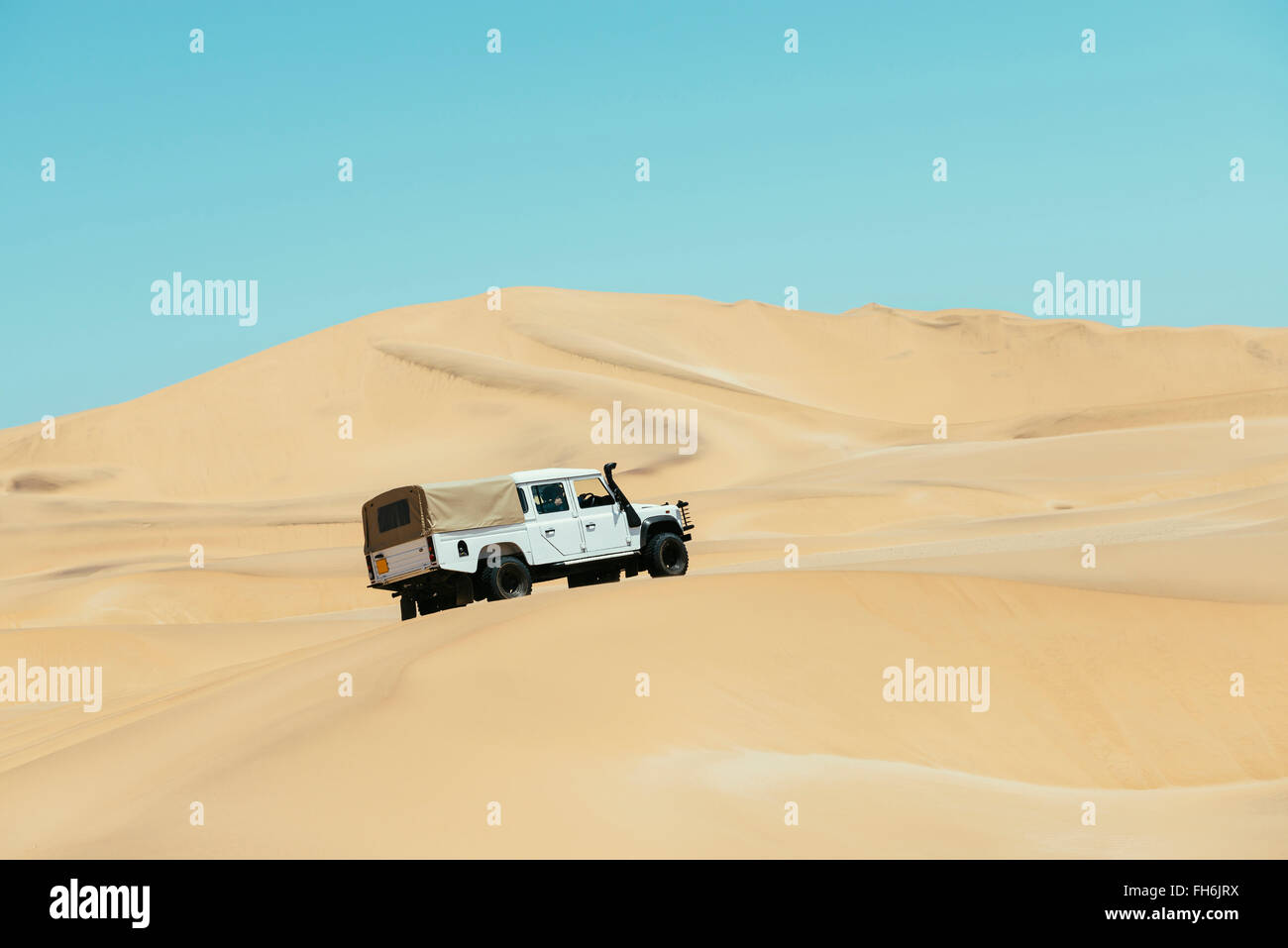 Namibia, Namib desert, Swakopmund, 4x4 car driving among the dunes in ...