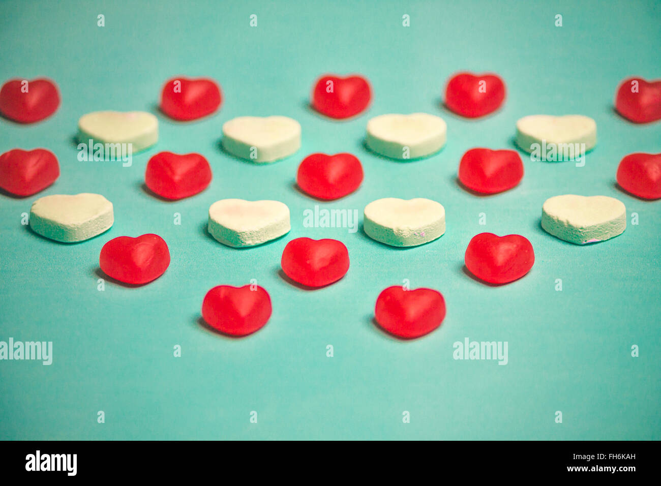 Valentine's Day Red Gummy and Conversation Hearts on Blue Background