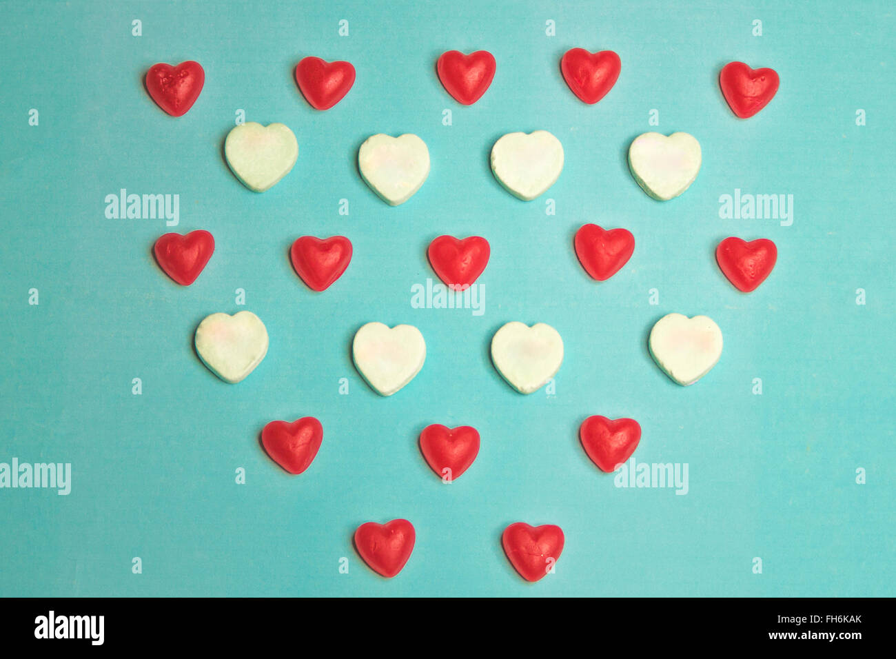 Valentine's Day Red Gummy and Conversation Hearts on Blue Background