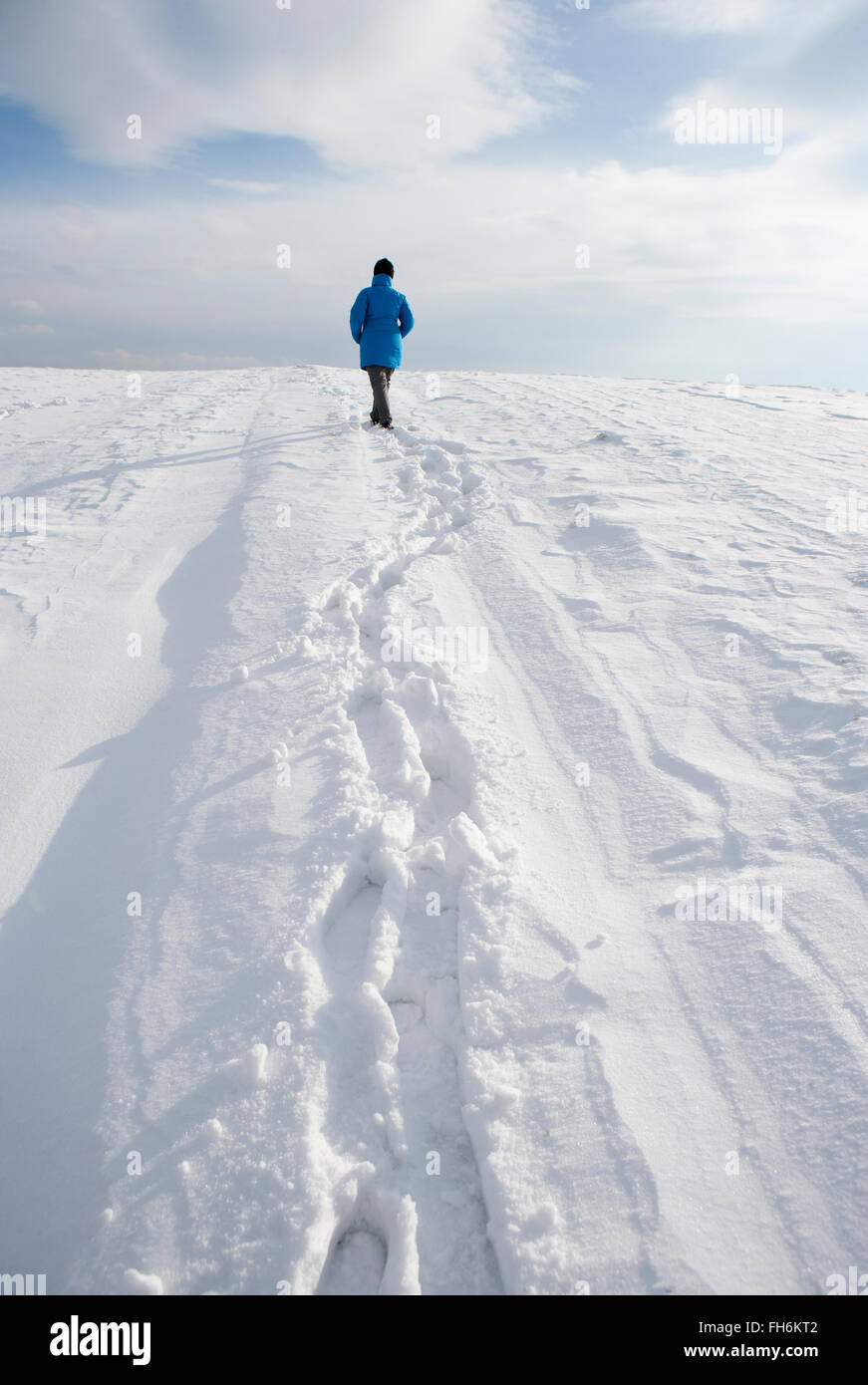 Woman walking in snow Stock Photo