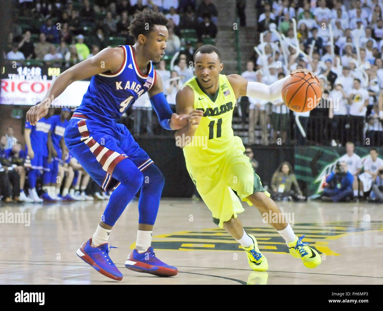 February 23, 2016: Baylor guard Lester Medford (11) drives towards the basket against Kansas guard Devonte' Graham (4) during the second half of an NCAA college basketball game between the Kansas Jayhawks and Baylor Bears at the Ferrell Center. Kansas won 66-60. Austin McAfee/CSM Stock Photo