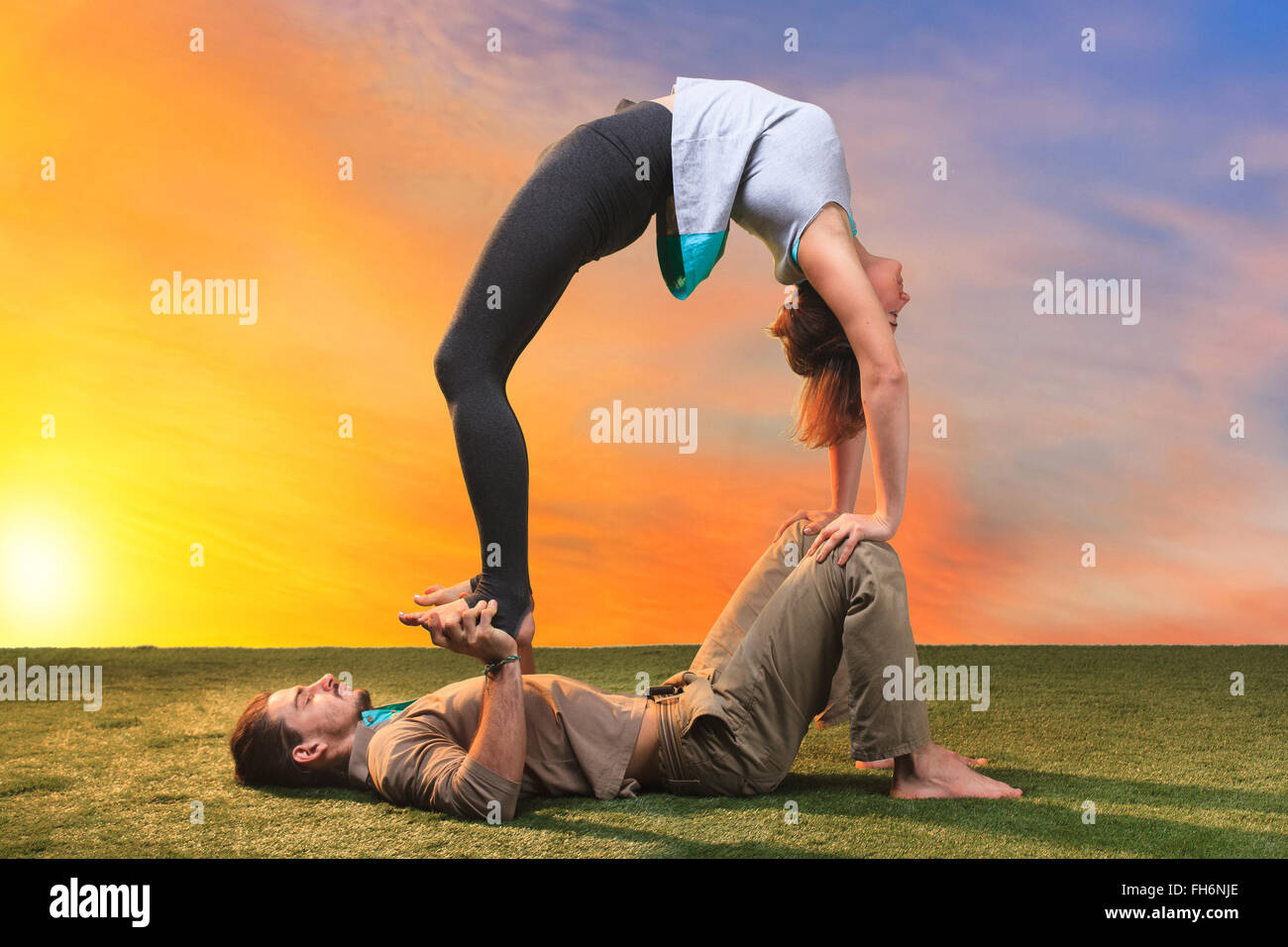 The two people doing yoga exercises Stock Photo - Alamy