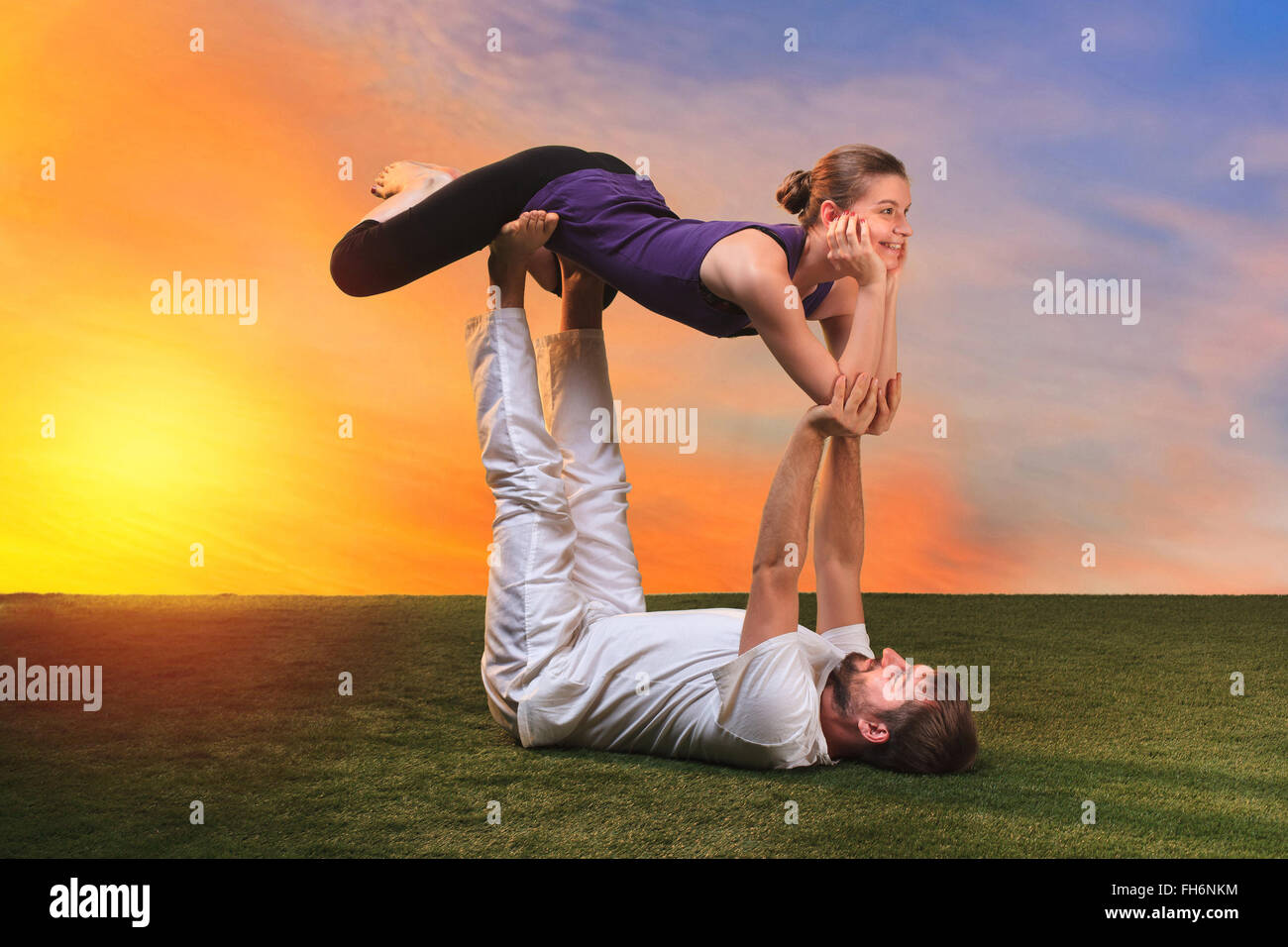The two people doing yoga exercises Stock Photo - Alamy