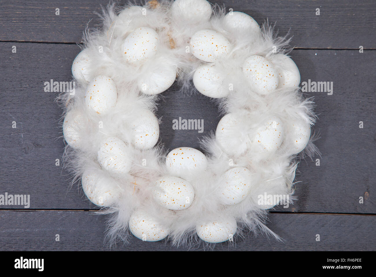 White wreath with white eggs on dark wooden background Stock Photo