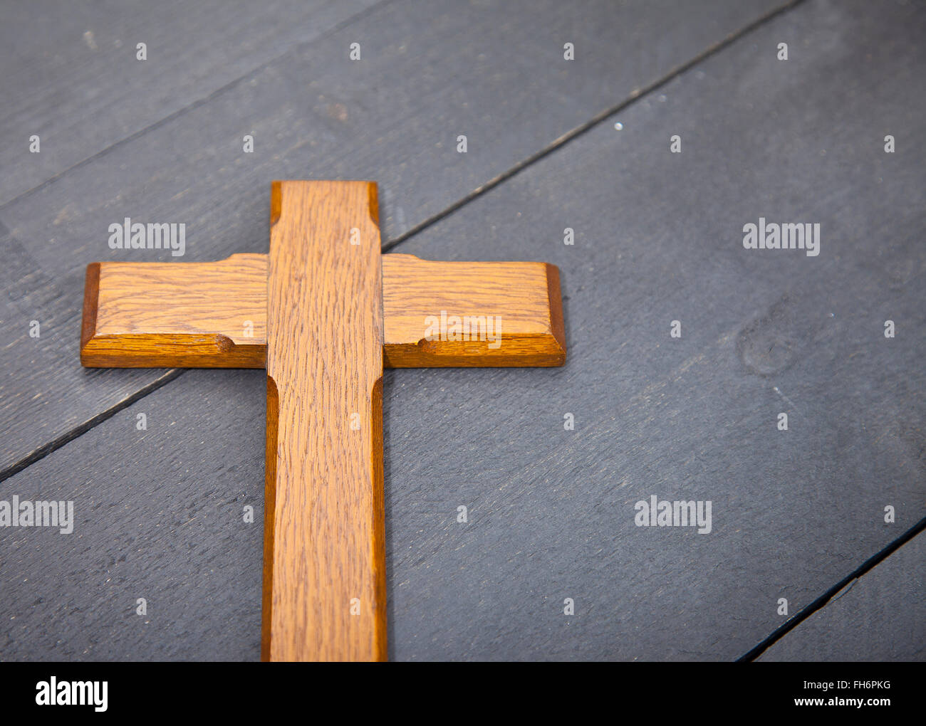 Wooden easter cross on black wooden background Stock Photo Alamy