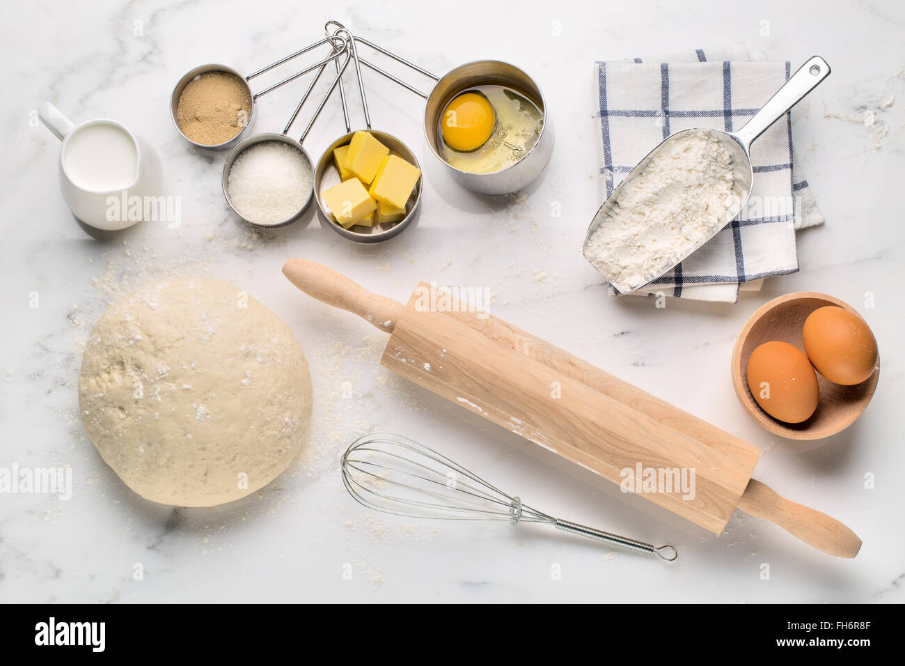 Baking cake, dough recipe ingredients (eggs, flour, milk, butter, sugar) on white table. Stock Photo