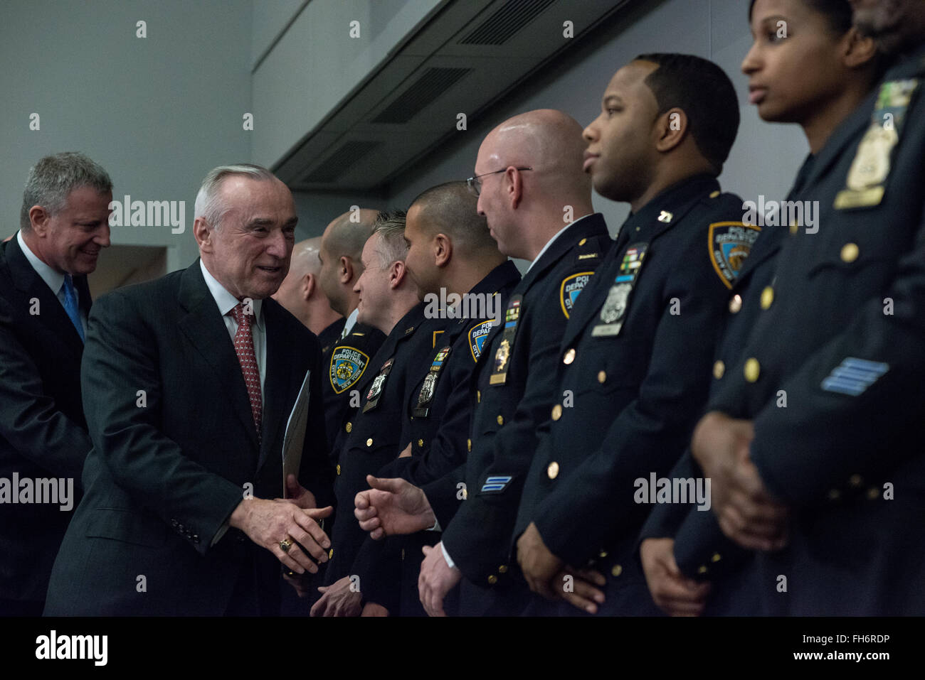 New York, United States. 23rd Feb, 2016. Commissioner Bratton (left) greets a line of NYPD officers on hand for the briefing who had used the new department communications tools. NYC Mayor Bill de Blasio and Police Commissioner William Bratton held a press briefing at One Police Plaza, the headquarters of the NYPD, to announce the launch of 'CompStat 2.0,' a new system for both publicly sharing crime data and enabling much accelerated distribution of vital police information resources among officers in the field. Credit:  Albin Lohr-Jones/Pacific Press/Alamy Live News Stock Photo