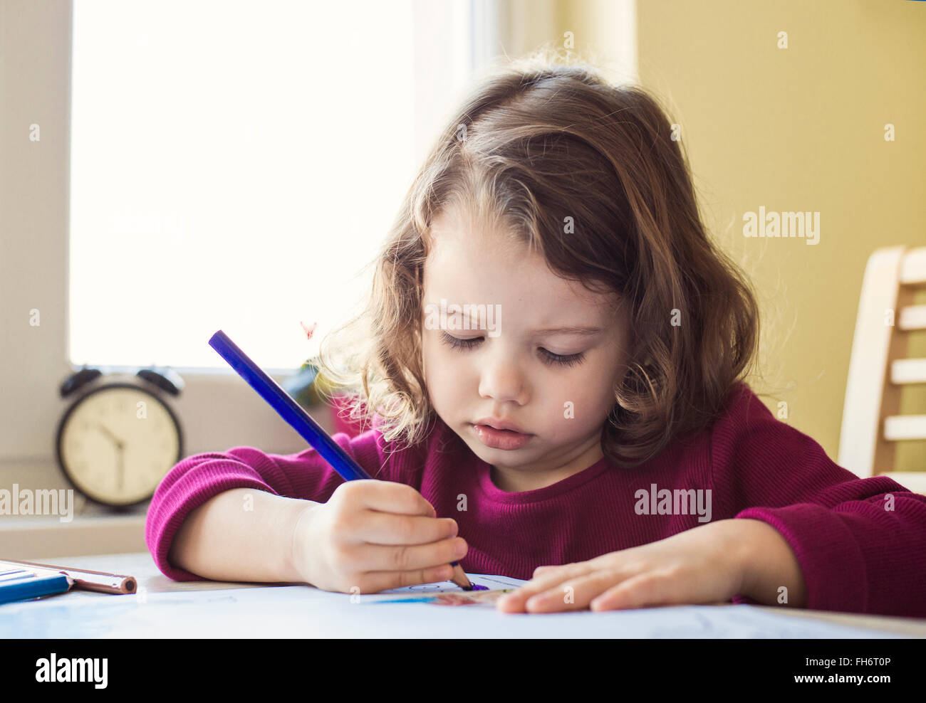 Portrait of little girl painting with coloured pencil Stock Photo Alamy