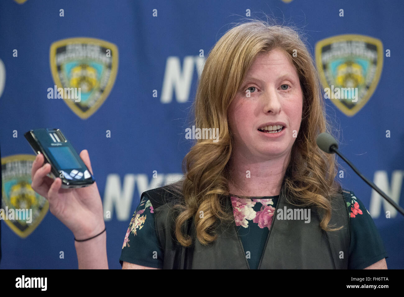 New York, United States. 23rd Feb, 2016. NYPD Deputy Commissioner of Information Technology Jessica Tisch displays the new digital fingerprinting scanner that will be issued to police officers. NYC Mayor Bill de Blasio and Police Commissioner William Bratton held a press briefing at One Police Plaza, the headquarters of the NYPD, to announce the launch of 'CompStat 2.0,' a new system for both publicly sharing crime data and enabling much accelerated distribution of vital police information resources among officers in the field. Credit:  Albin Lohr-Jones/Pacific Press/Alamy Live News Stock Photo