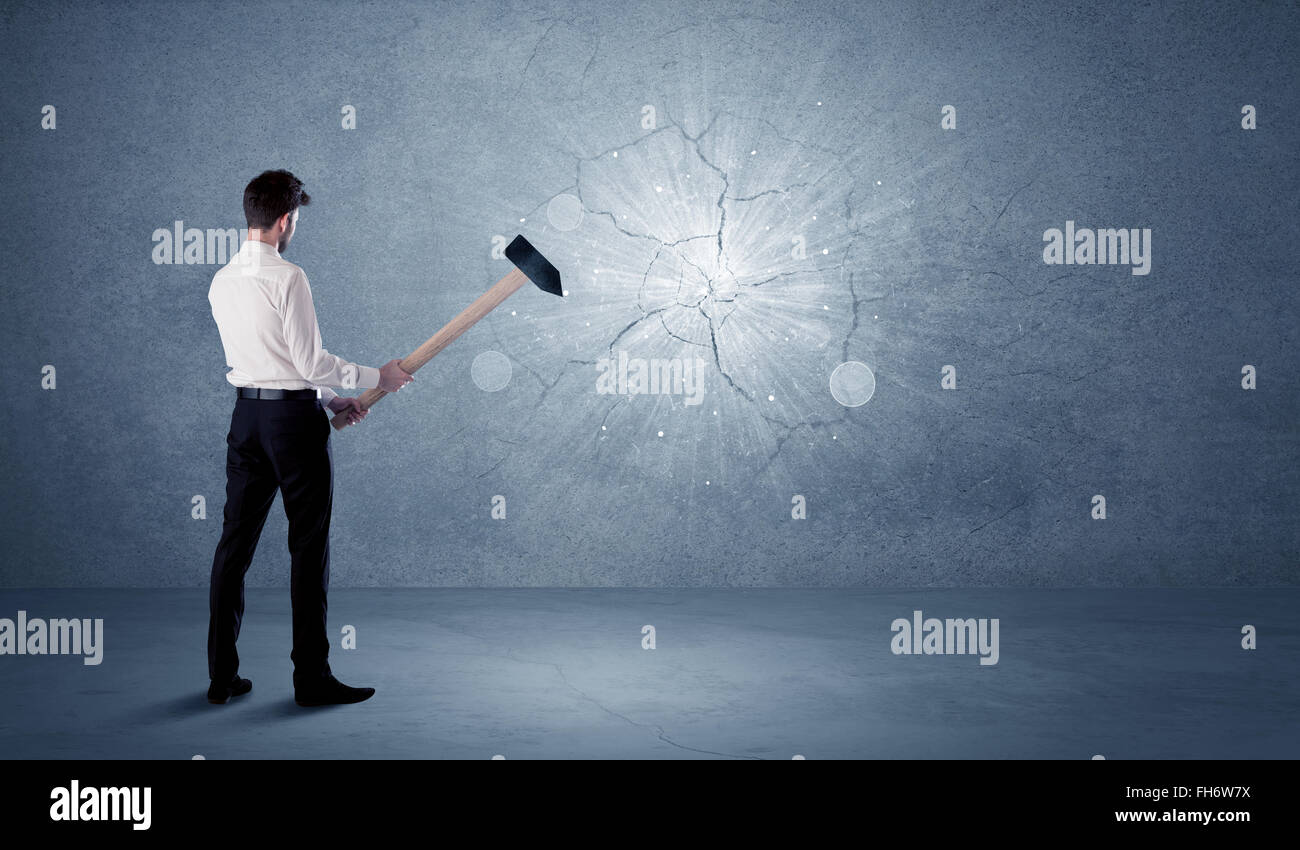 Man hitting wall with sledgehammer hi-res stock photography and