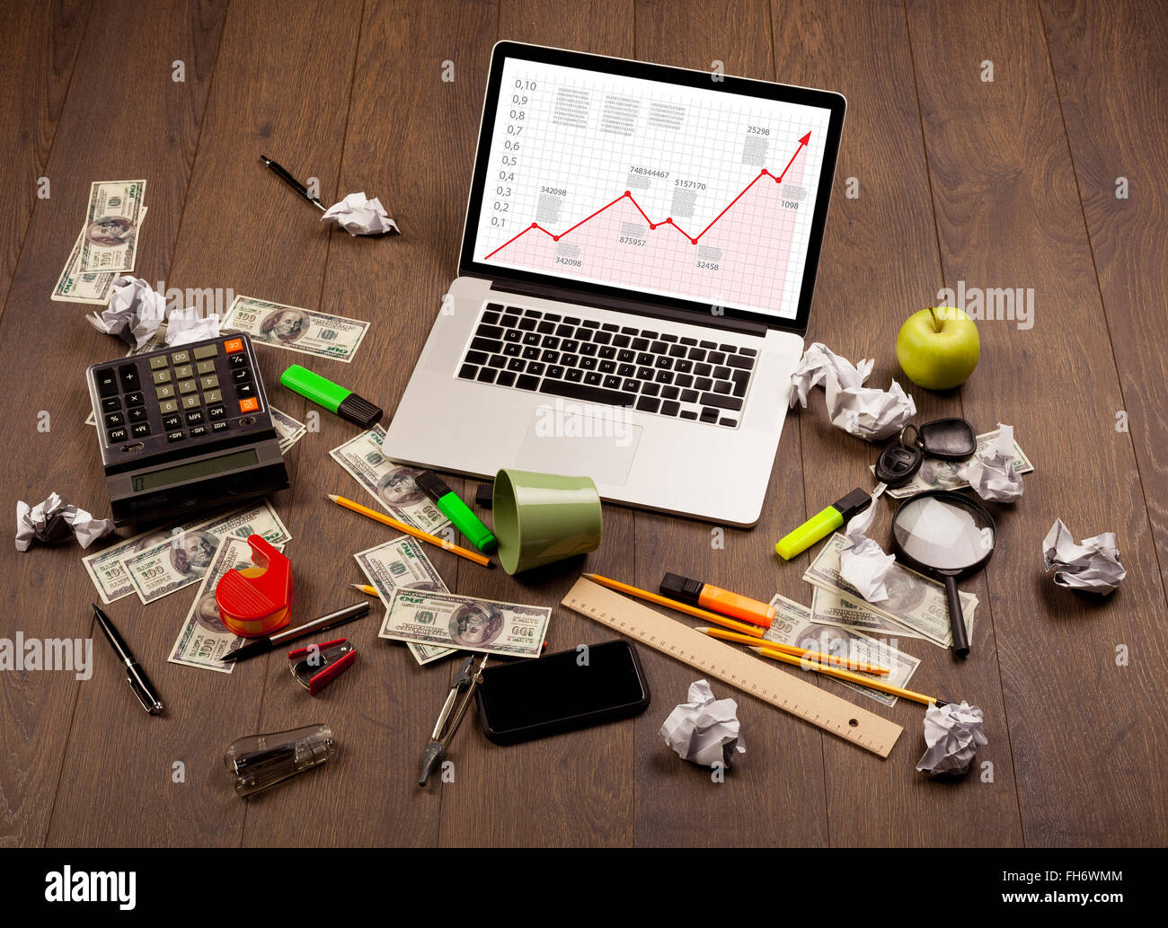 Computer desk with laptop and red arrow chart in screen Stock Photo - Alamy