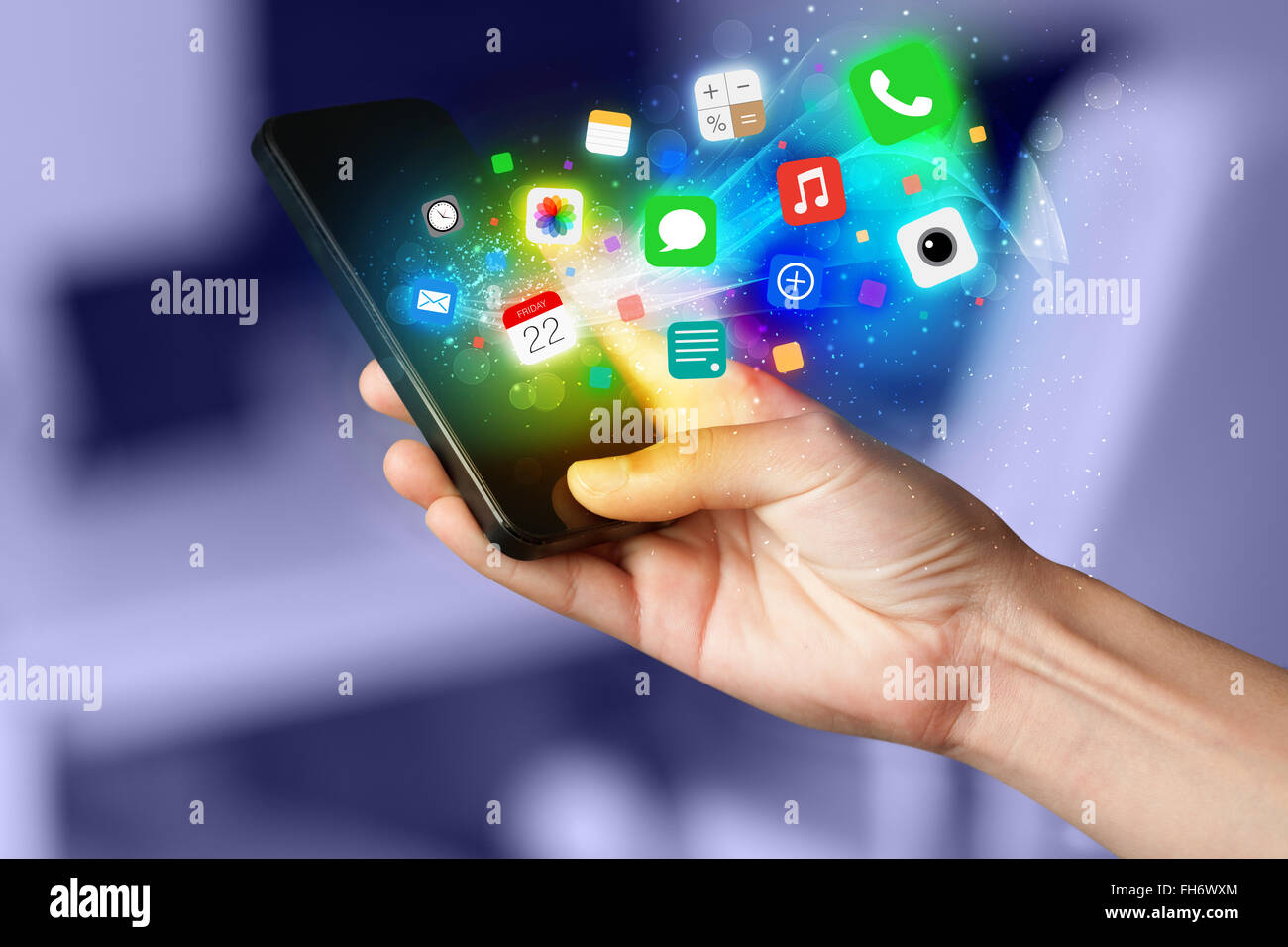 Hand holding smartphone with colorful app icons Stock Photo - Alamy