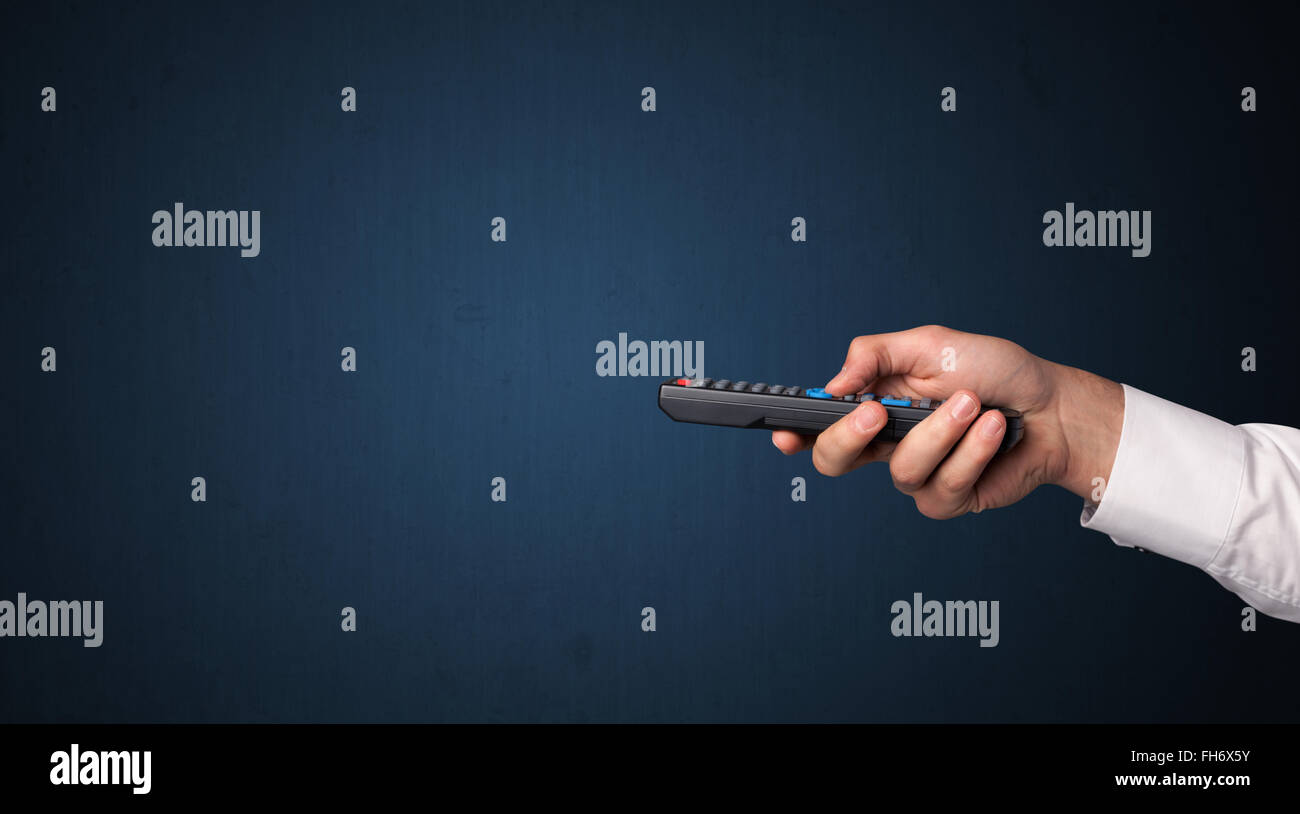 Hand with remote control Stock Photo - Alamy