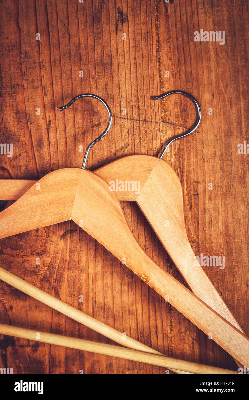 Two retro cloth hangers on rustic wooden background, top view with copy space Stock Photo