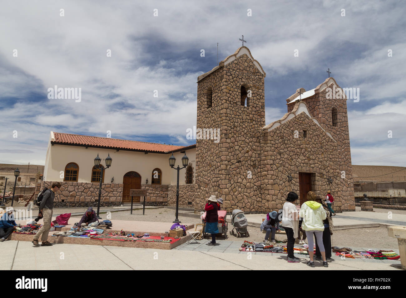 San Antonio de los Cobres, Argentina - November 14, 2015: People selling and buying handicrafts in front of the cathedral. Stock Photo