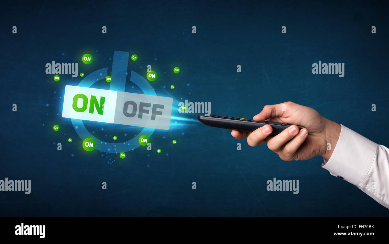 Hand with remote control and on-off signals Stock Photo - Alamy
