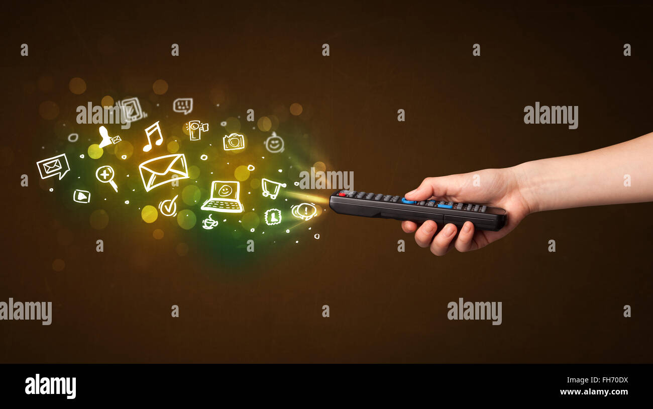 Hand with remote control and social media icons Stock Photo - Alamy