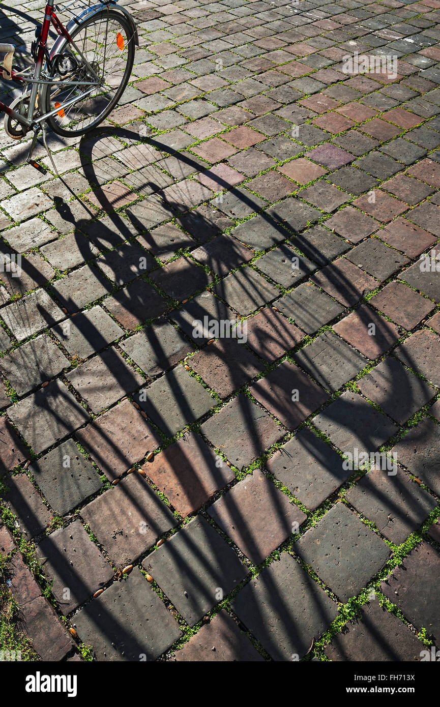 Paved square and shadow of a bicycle, Munich, Bavaria, Germany Stock Photo