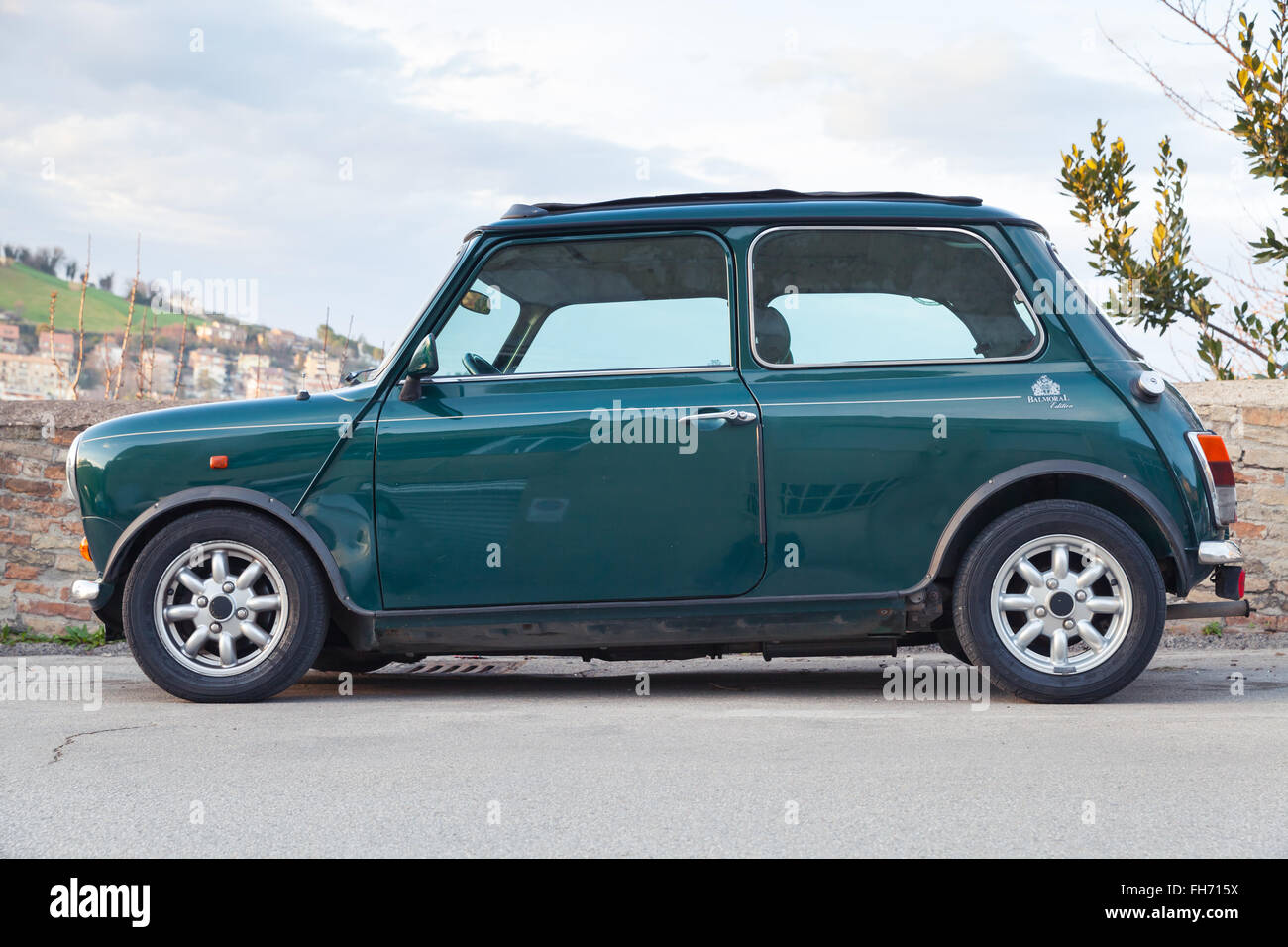 Fermo, Italy - February 8, 2016: Dark green Austin Mini Cooper Mk III side view. This modification of Mini is a small car Stock Photo