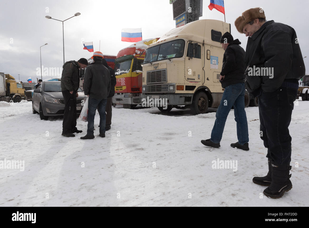 Saint Petersburg, Russia. 23 February 2016.  Truck drivers and their supporters gather to protest against the new road payment system, named 'Platon'. Truckers camp in the parking lot at the shopping center 'MEGA Dybenko' in St. Petersburg Credit:  Anton Veselov/Alamy Live News Stock Photo