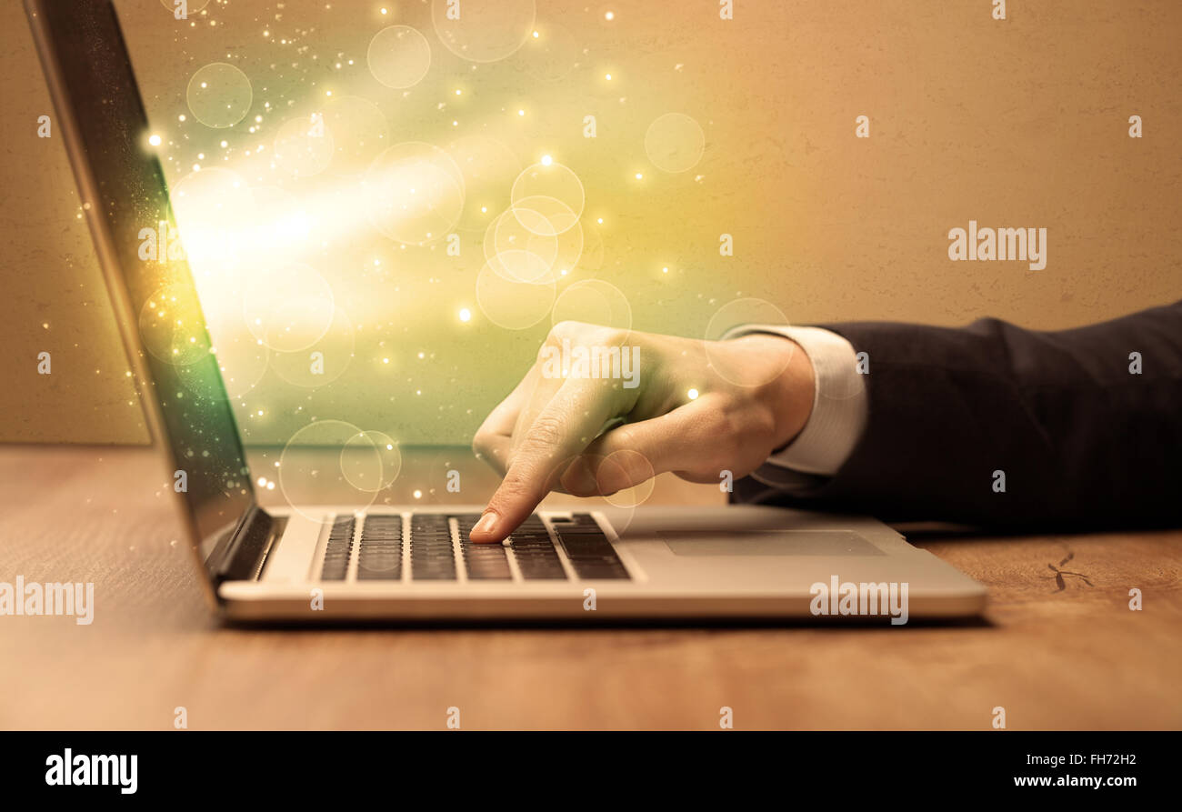 Businessman working fast on laptop Stock Photo - Alamy