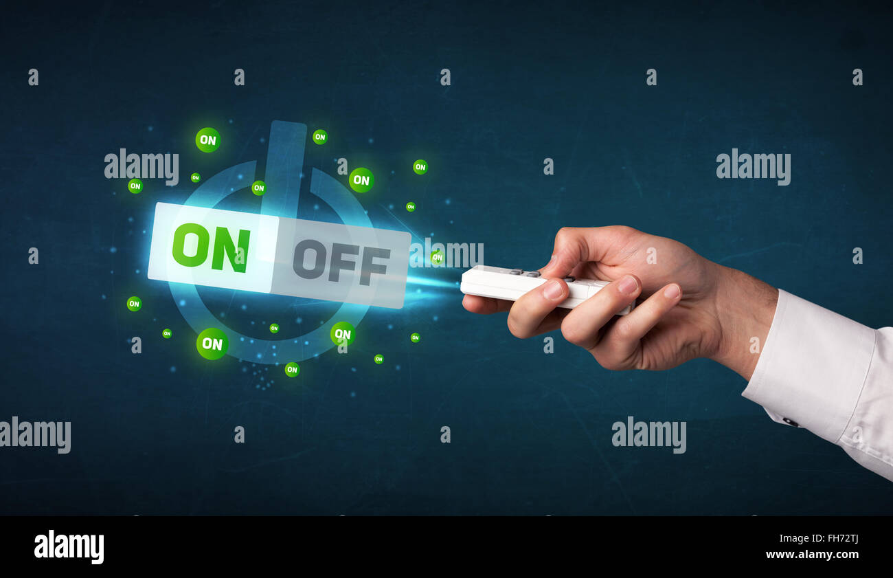 Hand with remote control and on-off signals Stock Photo - Alamy