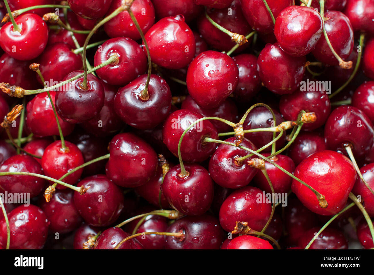 Ripe cherries background Stock Photo - Alamy
