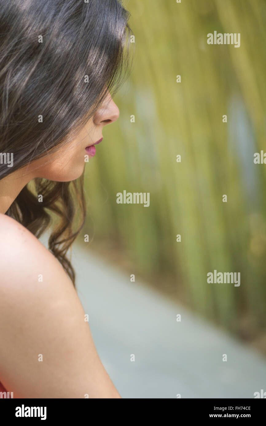 Young woman sitting outdoors hi-res stock photography and images - Alamy