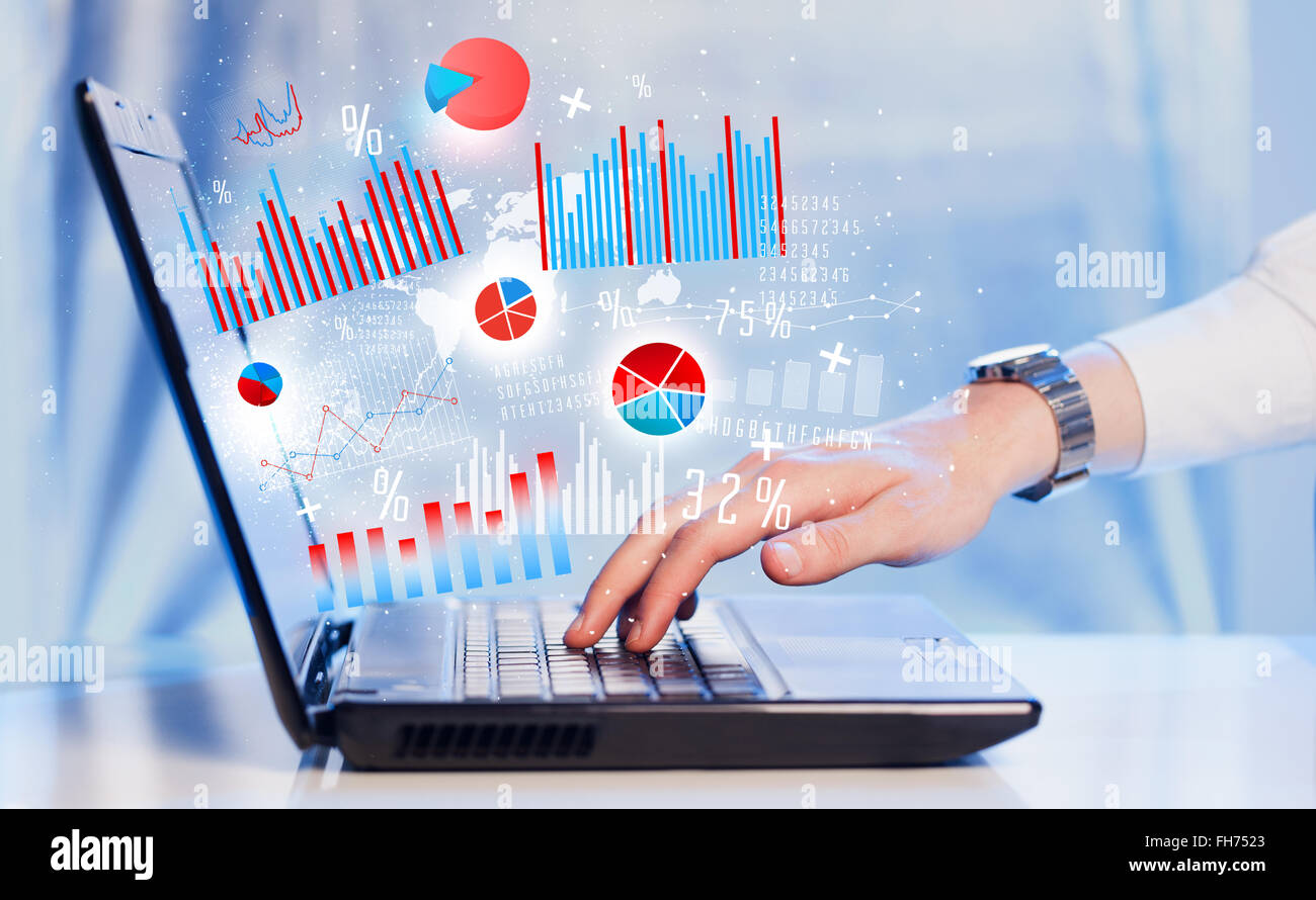 Hand typing on modern laptop notebook computer with graph icons and ...