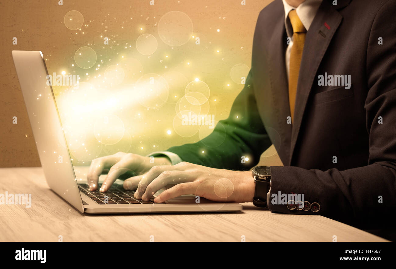 Businessman working fast on laptop Stock Photo - Alamy